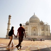 young couple walking in the taj mahal courtyard - travel stock pictures, royalty-free photos & images