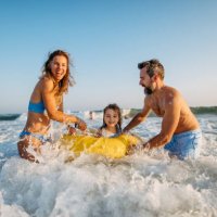 young family enjoying time at sea. - travel stockfoto's en -beelden