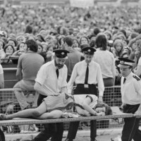 Young fan is carried out on a stretcher after being injured in a gate stampede at a concert by American singer and actor David Cassidy at White City...