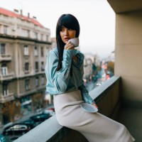 young fashionable and beautiful woman drinking coffee on the balcony - fashion stock pictures, royalty-free photos & images