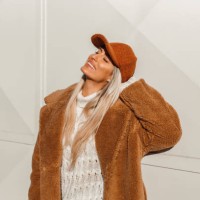young fashionable woman wearing a fake fur coat and a cap - fashion stock pictures, royalty-free photos & images
