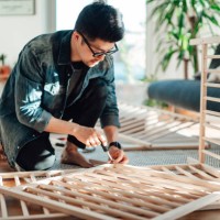 young father assembling baby cot at home - home decoration stock pictures, royalty-free photos & images