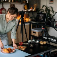 young female food photographer setting everything up for shooting - food stock pictures, royalty-free photos & images