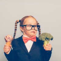 young female nerd holds ice cream and broccoli - junk food stock pictures, royalty-free photos & images