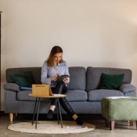 young female student sitting on the sofa and studying for exam at the university - home decoration stock pictures, royalty-free photos & images