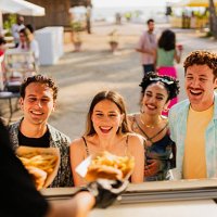 young friends buying snacks outdoors - concert stock pictures, royalty-free photos & images