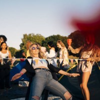 young friends performing limbo dance while camping in music festival - concert stock pictures, royalty-free photos & images