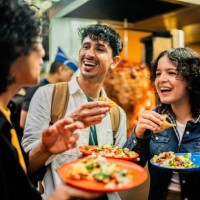 young friends talking and eating taco outdoors - food stock pictures, royalty-free photos & images