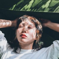 young gen-z female relaxing at home - hairstyle stockfoto's en -beelden