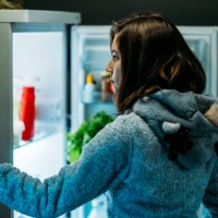 young girl at night in front of a refrigerator - junk food stock pictures, royalty-free photos & images