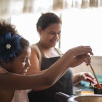 young girl cooking with her mother - food stock pictures, royalty-free photos & images