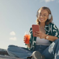 young girl, headphones and cellphone in city with cool drink, mobile texting and social media app on mockup sky. happy gen z woman, urban influencer and listening to music with smartphone outdoor - fashion stock pictures, roy