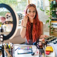 young girl using social media shoots makeup video in her room - fashion stock pictures, royalty-free photos & images