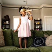 young girl wearing homemade crown and looking through homemade telescope - home decoration stock pictures, royalty-free photos & images