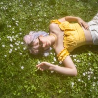 young girl with colored hair lies on the daisy blooming grass - fashion stock pictures, royalty-free photos & images