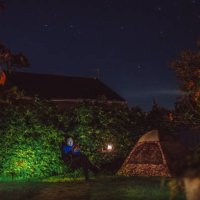 young handsome man reading with his ebook reader next to a camping tent in the backyard of house - garden decoration stock pictures, royalty-free photos & images