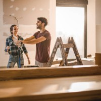 young happy couple enjoying in home renovation process. - home decoration stock pictures, royalty-free photos & images