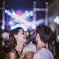 young happy couple having fun on music concert at night. - concert stock pictures, royalty-free photos & images