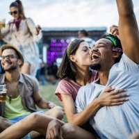 young happy couple having fun with friends on a music festival. - concert stock pictures, royalty-free photos & images