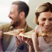 young happy family eating pizza for lunch at home. - junk food stock pictures, royalty-free photos & images