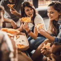 young happy friends having fun while eating pizza at home. - junk food stock pictures, royalty-free photos & images