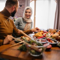 young happy muslim woman enjoying in ramadan meal with her friends - food stock pictures, royalty-free photos & images