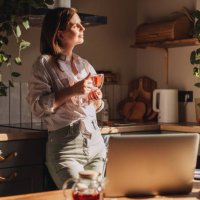 young happy woman drinking coffee on the kitchen in the morning. - coffee stock pictures, royalty-free photos & images