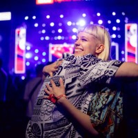 young happy woman embracing her boyfriend during a music festival at night. - concert stock pictures, royalty-free photos & images