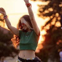young happy woman having fun while dancing on a music festival at sunset. - concert stock pictures, royalty-free photos & images
