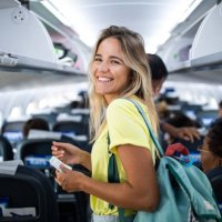 young happy woman in an airplane cabin. - travel stock pictures, royalty-free photos & images