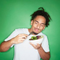 young hipster man eating salad - food stock pictures, royalty-free photos & images