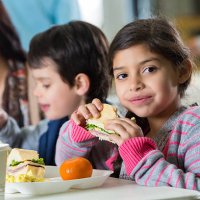 young hispanic family eating meal at neighborhood soup kitchen - food stock pictures, royalty-free photos & images