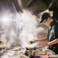 young japanese chef working in restaurant kitchen - junk food stock pictures, royalty-free photos & images