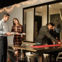 young latin people setting table for christmas meal - garden decoration stock pictures, royalty-free photos & images