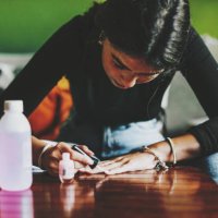 young latina f woman with long, slender fingers, paints her nails at home - nails art stock pictures, royalty-free photos & images