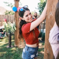 young latino people decorating at the backyard party - garden decoration stock pictures, royalty-free photos & images