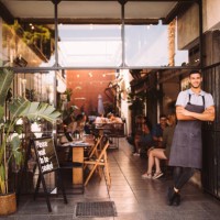 young male business owner standing outside hipster urban café - food stock pictures, royalty-free photos & images