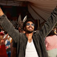 young man dancing with arms raised - concert stock pictures, royalty-free photos & images