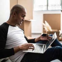 young man doing an online shopping for new home - home decoration stock pictures, royalty-free photos & images