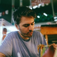 young man eating authentic thai food on a street market in bangkok, thailand - food stock pictures, royalty-free photos & images