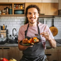 young man eating delicious and healthy dessert, pumpkin with honey and cinnamon. - food stock pictures, royalty-free photos & images