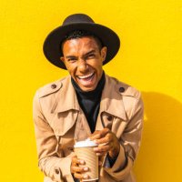 young man enjoying his take-out coffee - junk food stock pictures, royalty-free photos & images