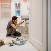 young man fixing a leak under the bathroom sink - home decoration stock pictures, royalty-free photos & images