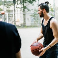 young man holding basketball ready to start the game - hairstyle stock pictures, royalty-free photos & images