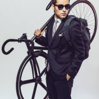 young man in suit with backpack and bike standing on white background - fashion stock pictures, royalty-free photos & images