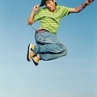 young man jumping in air, portrait, low angle - fashion stock-fotos und bilder