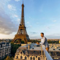 young man looking at the sunset from the balcony with eiffel tower in the background, paris, france - travel stock pictures, royalty-free photos & images