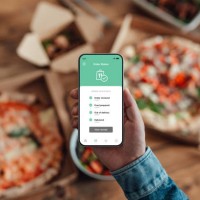 young man ordering food delivery via mobile app on smart phone. - junk food stock pictures, royalty-free photos & images