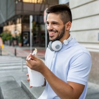 young man taking a break and eating fast food - junk food stock pictures, royalty-free photos & images