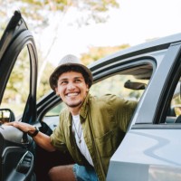 young man traveling by car getting out of the car - travel stock pictures, royalty-free photos & images